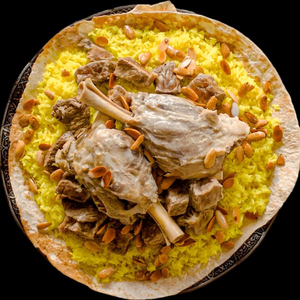 Desert Moon Mediterranean Grill's Mansaf, with lamb shanks, yellow rice, and almonds on flatbread.